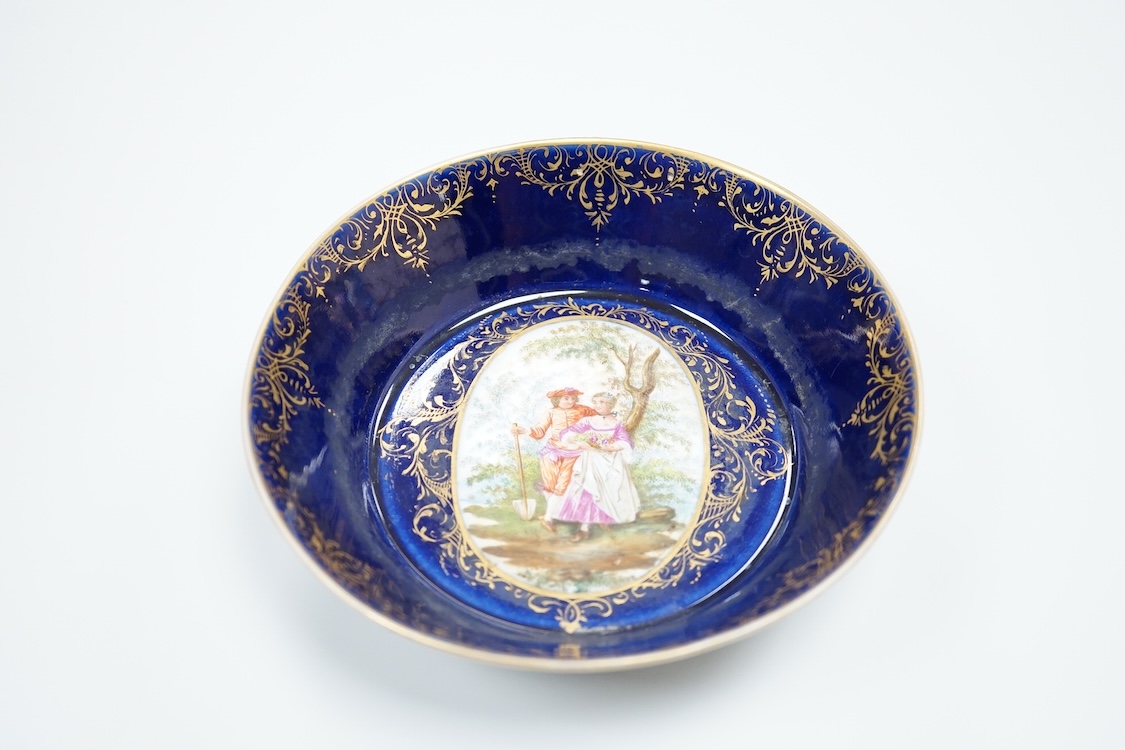 A 19th century Vienna saucer, hand painted with two figures beneath a tree, 15cm in diameter